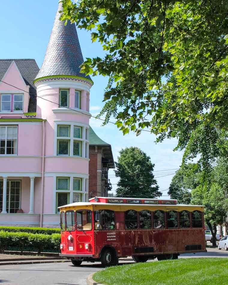 Old Fashioned Express trolley in front of the Pink House in Old Louisville