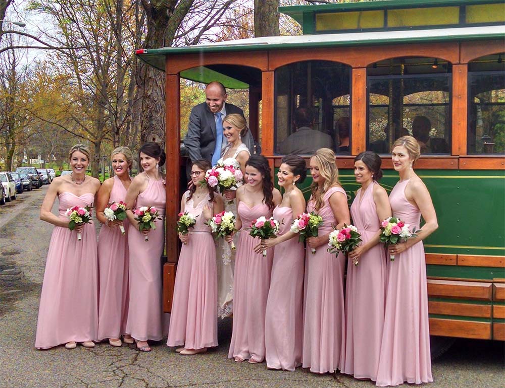 Wedding party posing in front of the historic Toonerville Trolley in Louisville Kentucky, wedding party transportation in Louisville