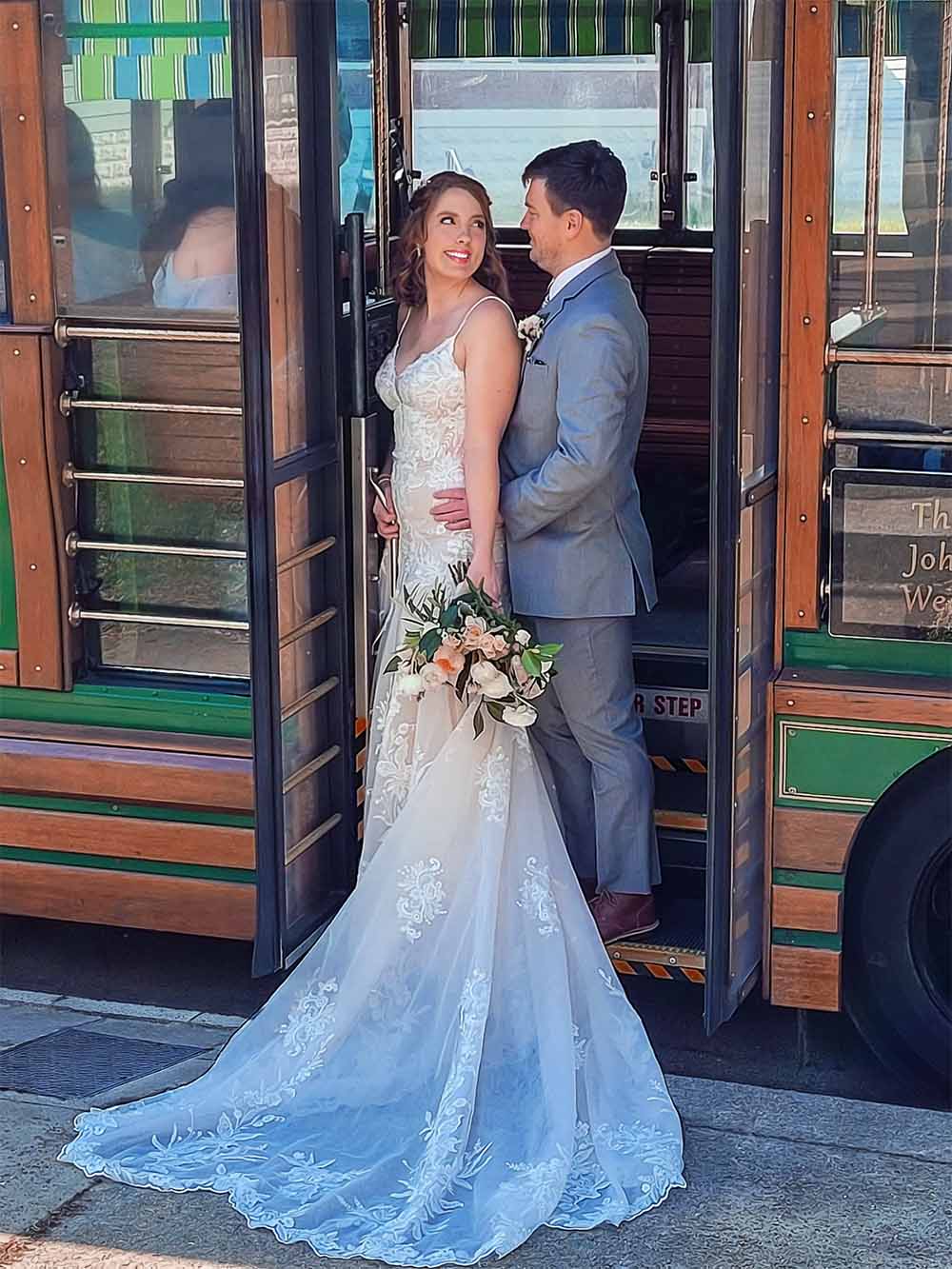 Bride and groom posing on the stairs of Louisville's historic Toonerville trolley during a wedding photo shoot