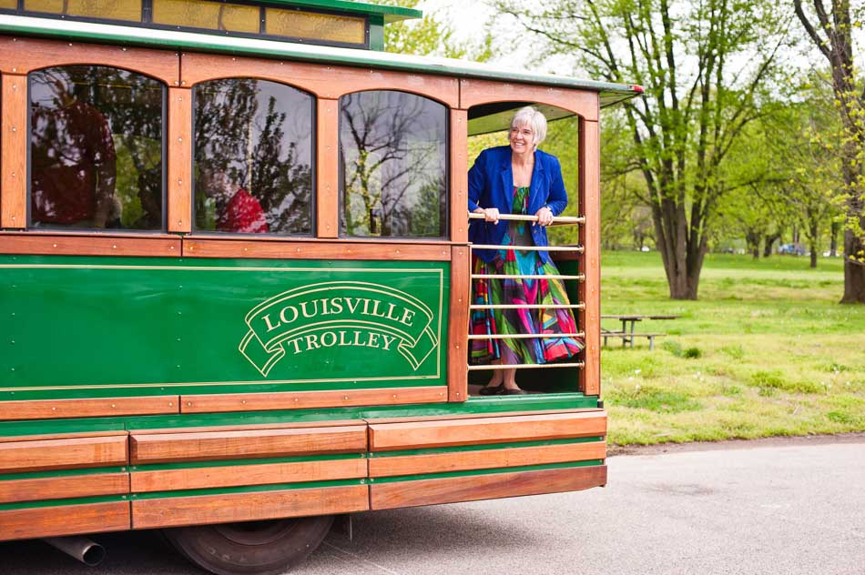 Fabulous older woman in brightly colored clothing on the balcony of the historic Toonerville trolley in Louisville Kentucky
